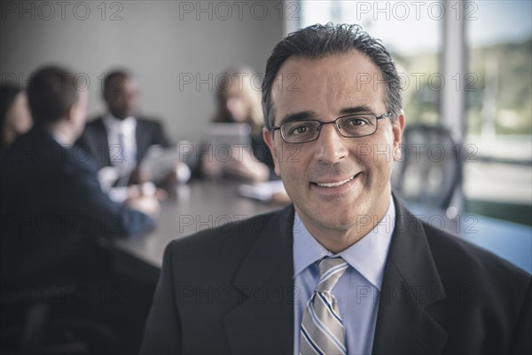 Businessman smiling in conference room