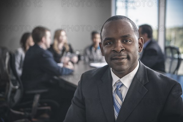 Businessman smiling in conference room