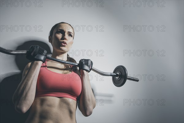 Caucasian woman lifting barbell