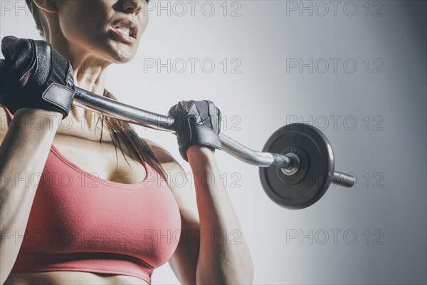 Caucasian woman lifting barbell