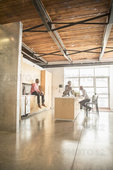 Business people relaxing in office kitchen