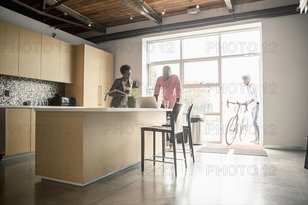 Business people talking in office kitchen