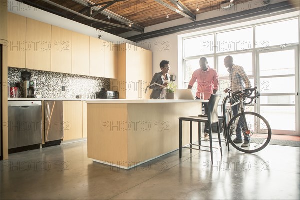 Business people talking in office kitchen