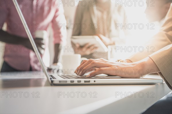 Businesswoman using laptop in office