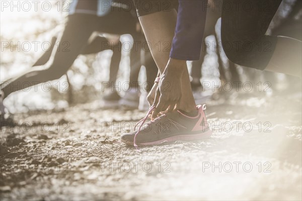 Close up of athlete tying shoe