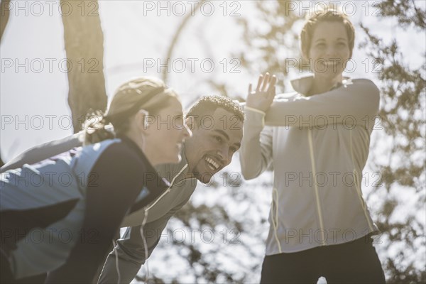 Close up of smiling athletes stretching