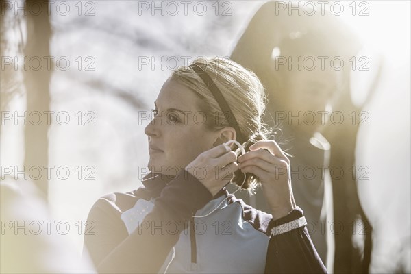 Close up of athlete putting on earbuds