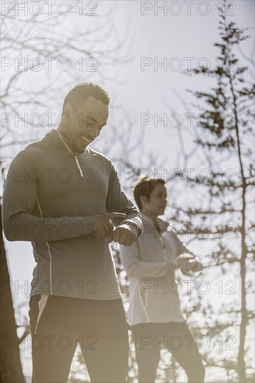 Athletes checking sports watches