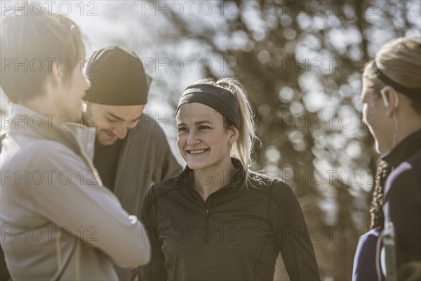 Smiling friends talking outdoors