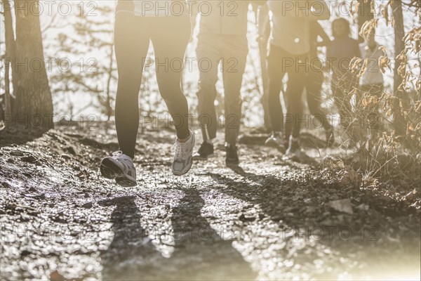 Runners jogging on dirt path