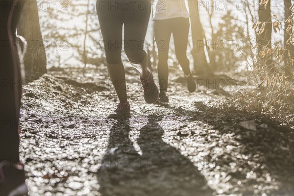 Runners jogging on dirt path