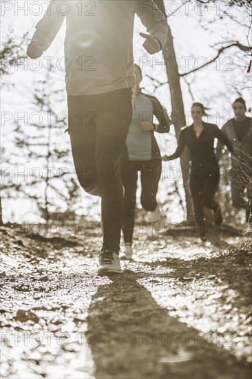 Runners jogging on dirt path