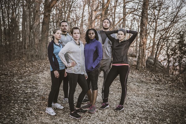 Runners standing on forest path