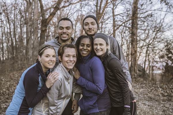 Runners smiling on forest path