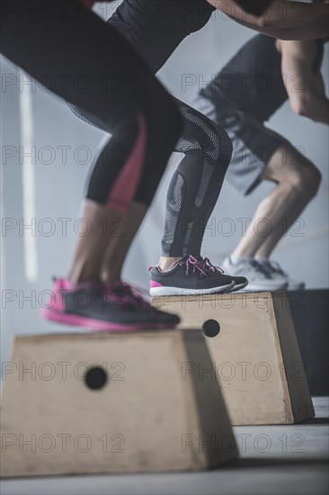 Athletes jumping on platforms in gym