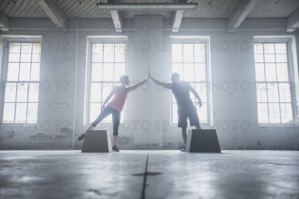 Silhouette of athletes high-fiving near platforms