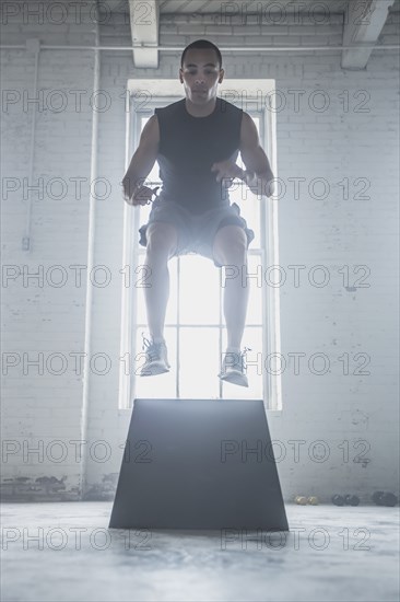 Athlete jumping on platform