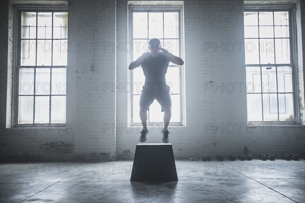 Athlete jumping on platform