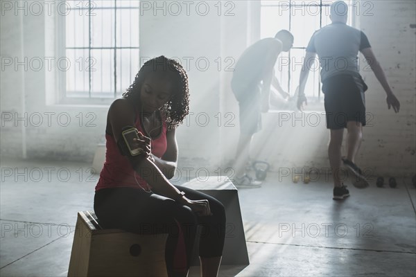 Athlete listening to mp3 player in gym