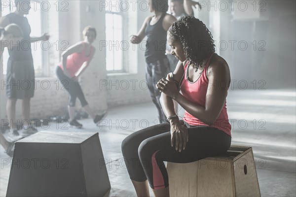 Athlete listening to mp3 player in gym