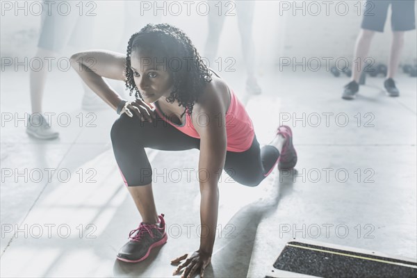 High angle view of athlete stretching in gym