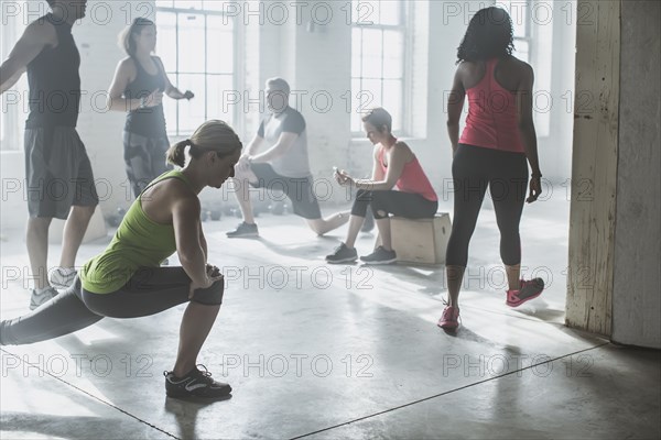 Athletes stretching in gym