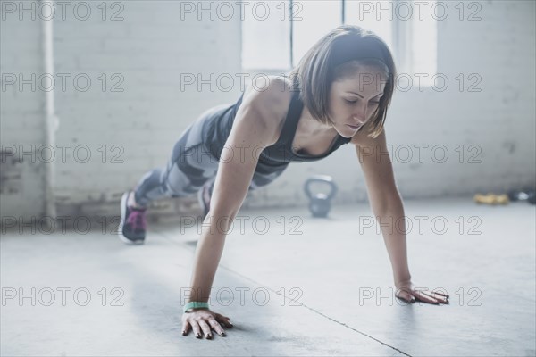 Athlete doing push-ups in gym