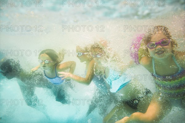 Children underwater in swimming pool