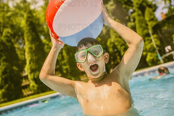 Caucasian boy playing in swimming pool