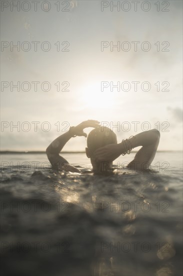 Caucasian woman swimming in still lake