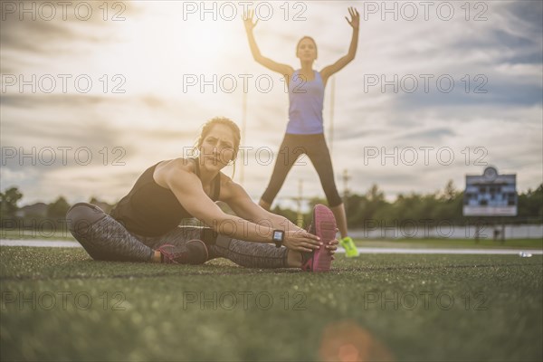 Athletes stretching on sports field