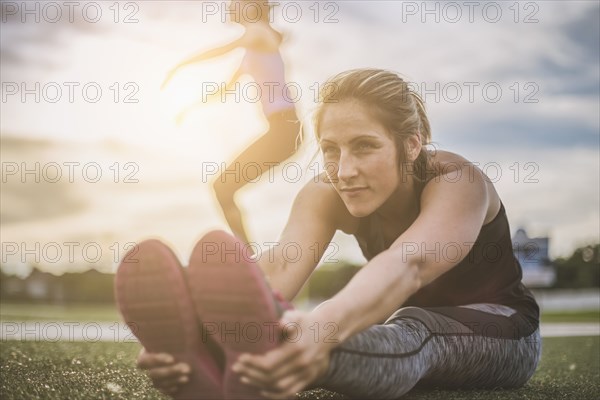 Athletes stretching on sports field