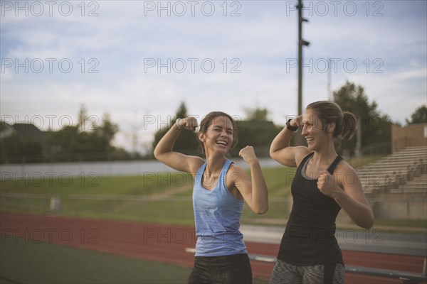 Athletes flexing their muscles on sports field