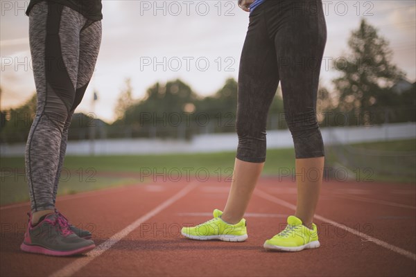 Athletes standing on track on sports field