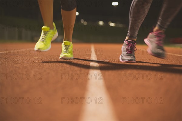 Athletes running on track on sports field
