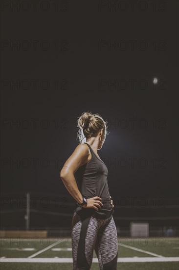 Caucasian athlete resting on sports field