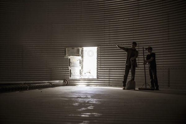 Caucasian father and on standing in empty silo