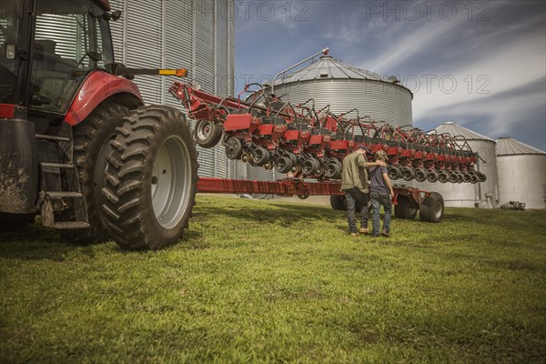 Caucasian farmer and son walking on farm