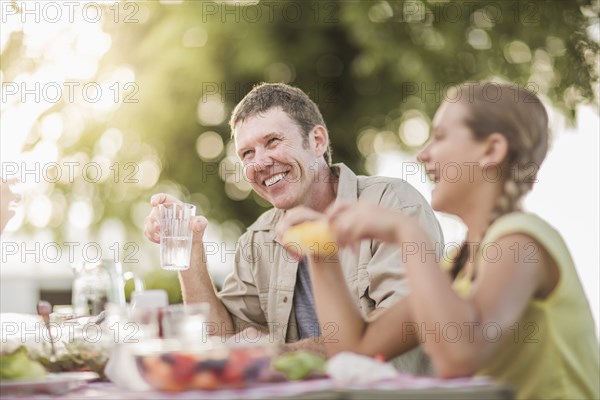 Caucasian family eating in backyard