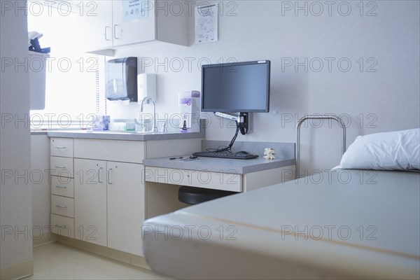 Empty bed and television in hospital room