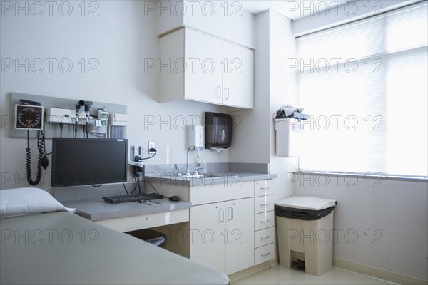 Empty bed and television in hospital room