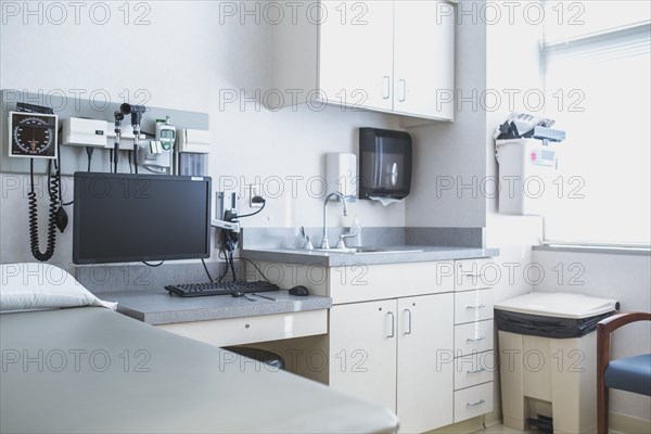 Empty bed and television in hospital room