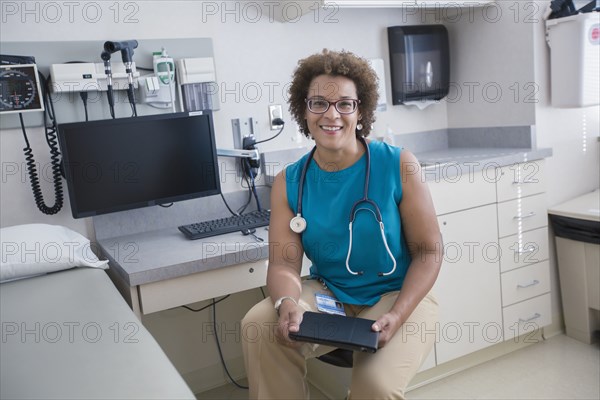 African American doctor holding digital tablet