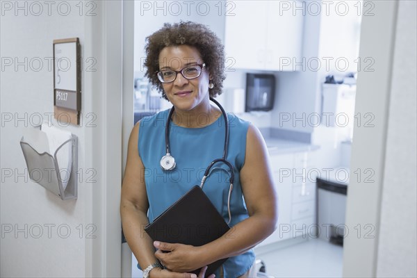 African American doctor holding digital tablet