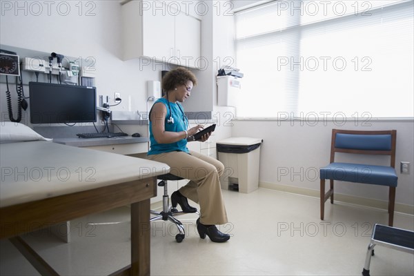 African American doctor using digital tablet