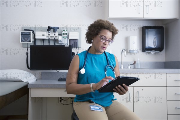 African American doctor using digital tablet