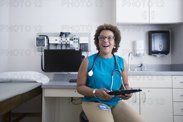 African American doctor holding digital tablet