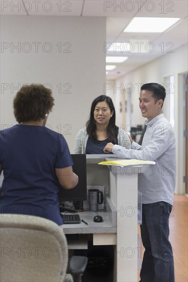 Nurse and patients talking in hospital