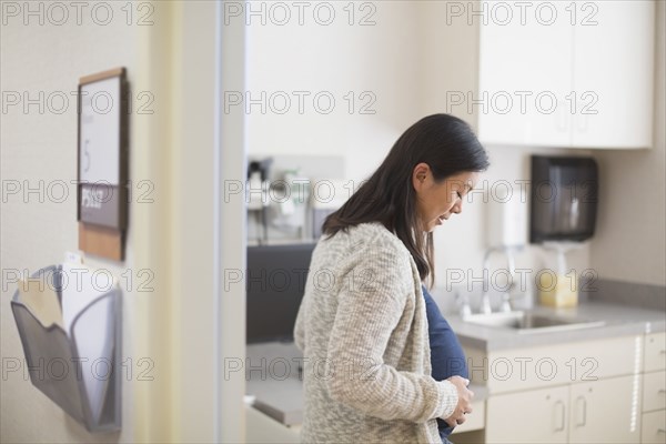 Pregnant Chinese woman in hospital room