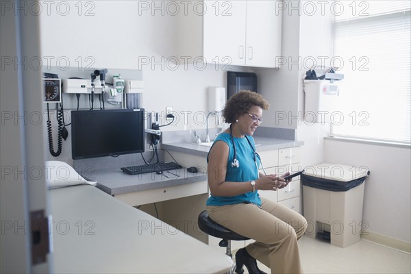 African American doctor using digital tablet